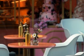 Close up image of cafe tables and chairs with decorative flowers