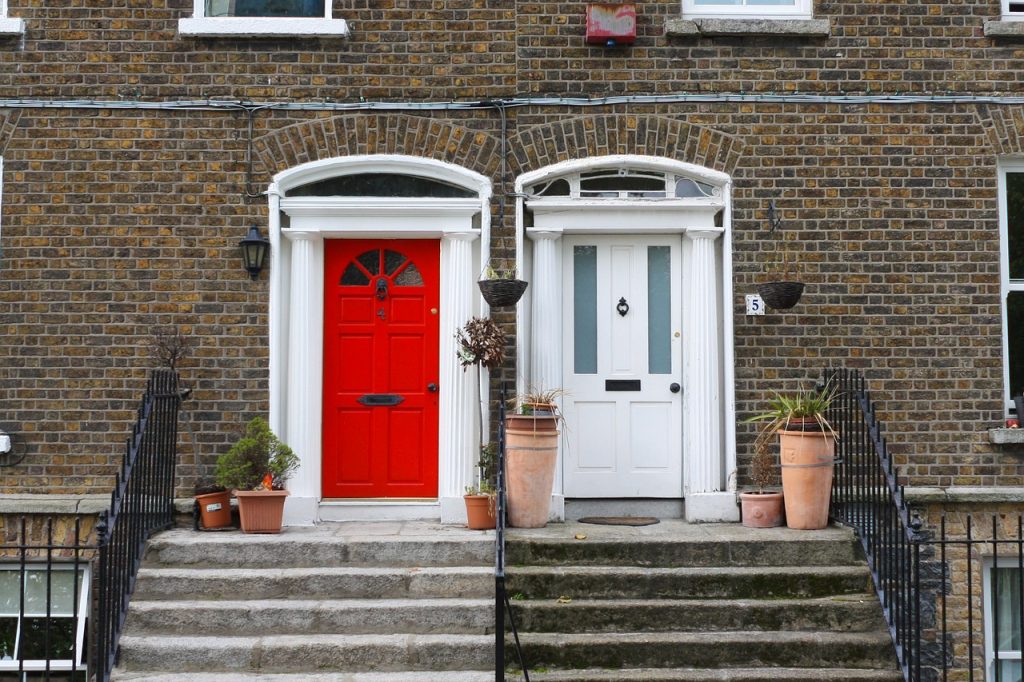 Image of terraced houses with wooden doors and ornate door furniture