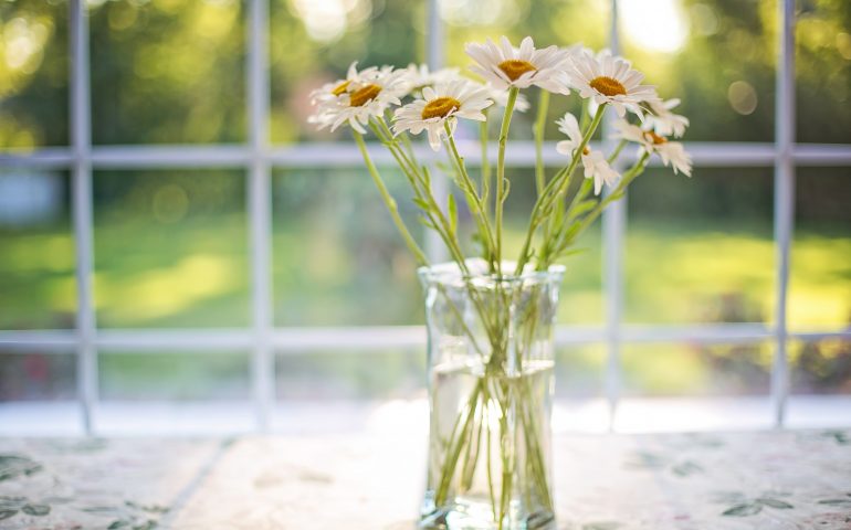 Image of a vase of flowers next to a replacement window