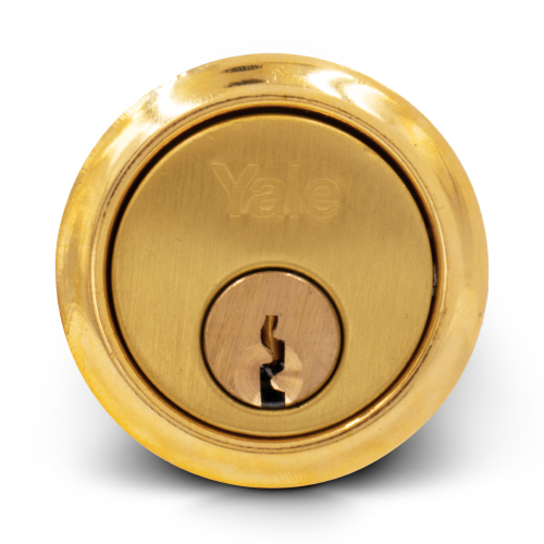 Close up product picture of a brass rim cylinder manufactured by Yale